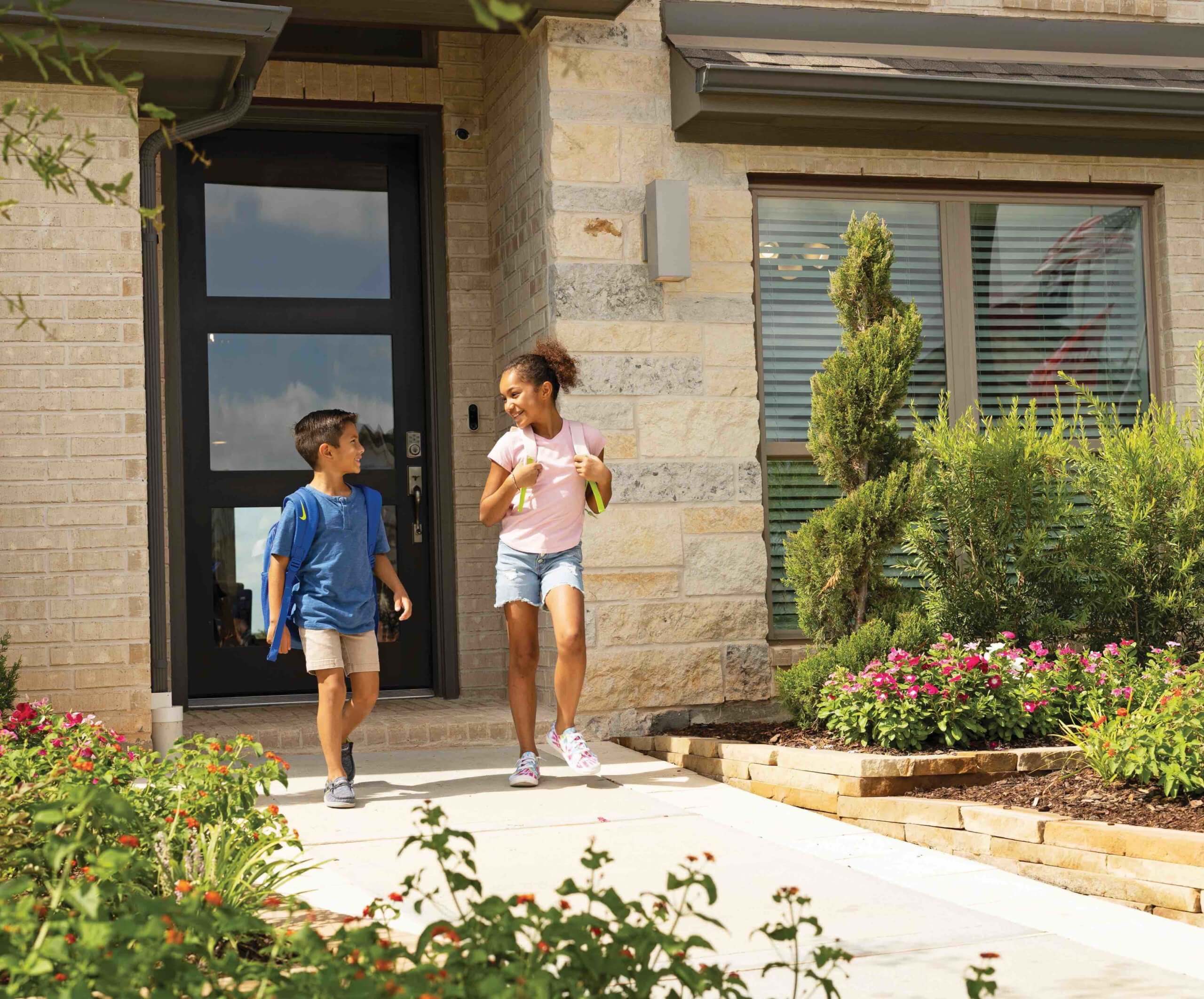 In the heart of Emberly, a master planned community in Fort Bend County, a group of children are gathered around a table, interacting with an electronic device and components, engaged in a collaborative activity indoors.